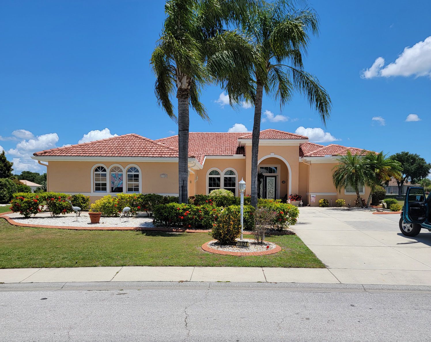 A large house with palm trees in front of it