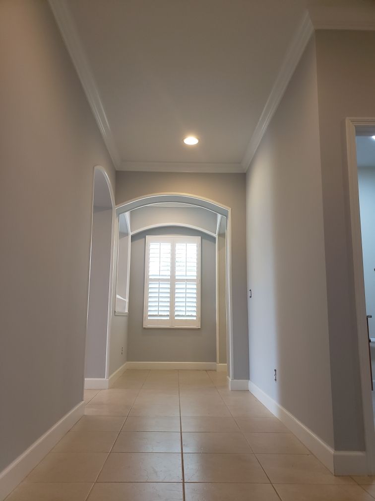A hallway with a window in the middle of it