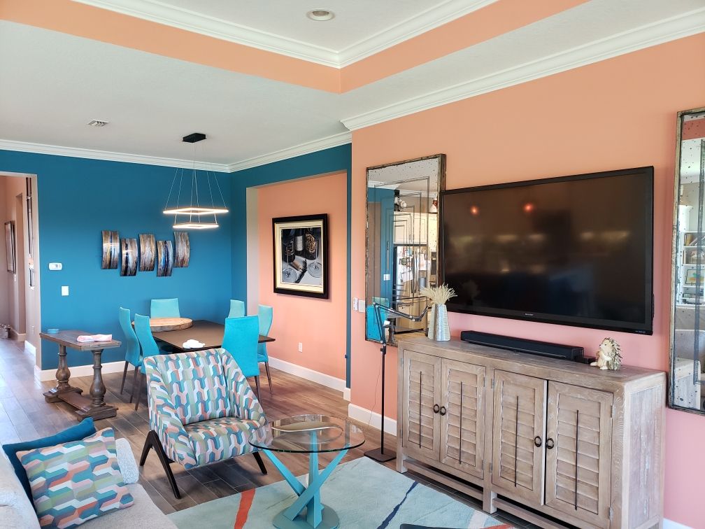 A living room with a flat screen tv on the wall
